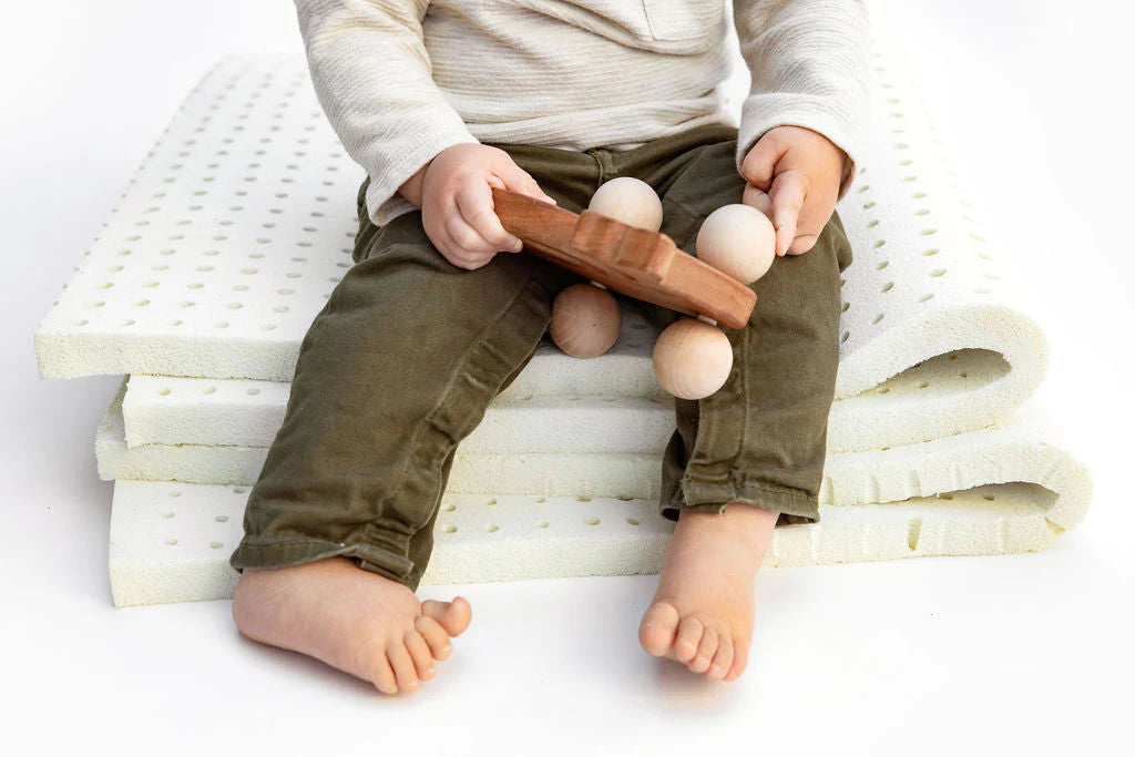 child sitting on latex foam