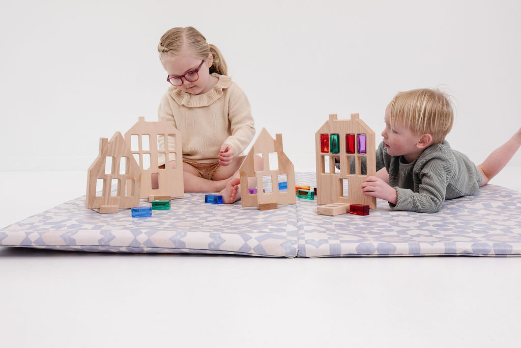 two kids playing with toys on their toki mats play mat