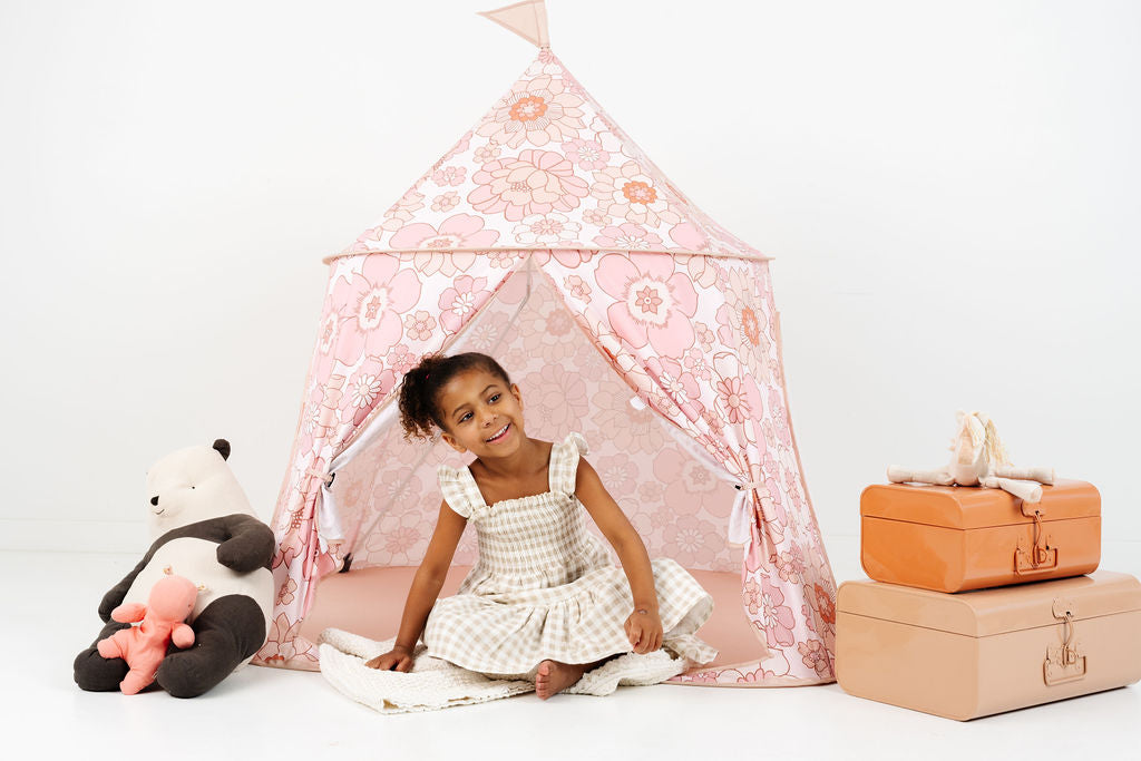toddler playing inside a toki mats play tent