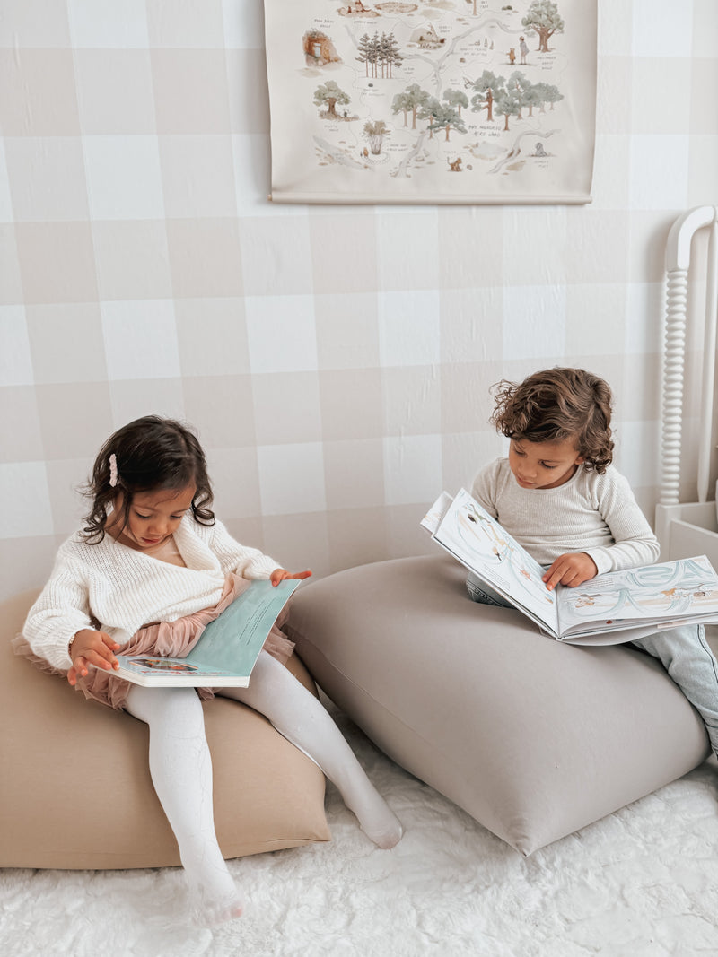 Two children reading on bean bags