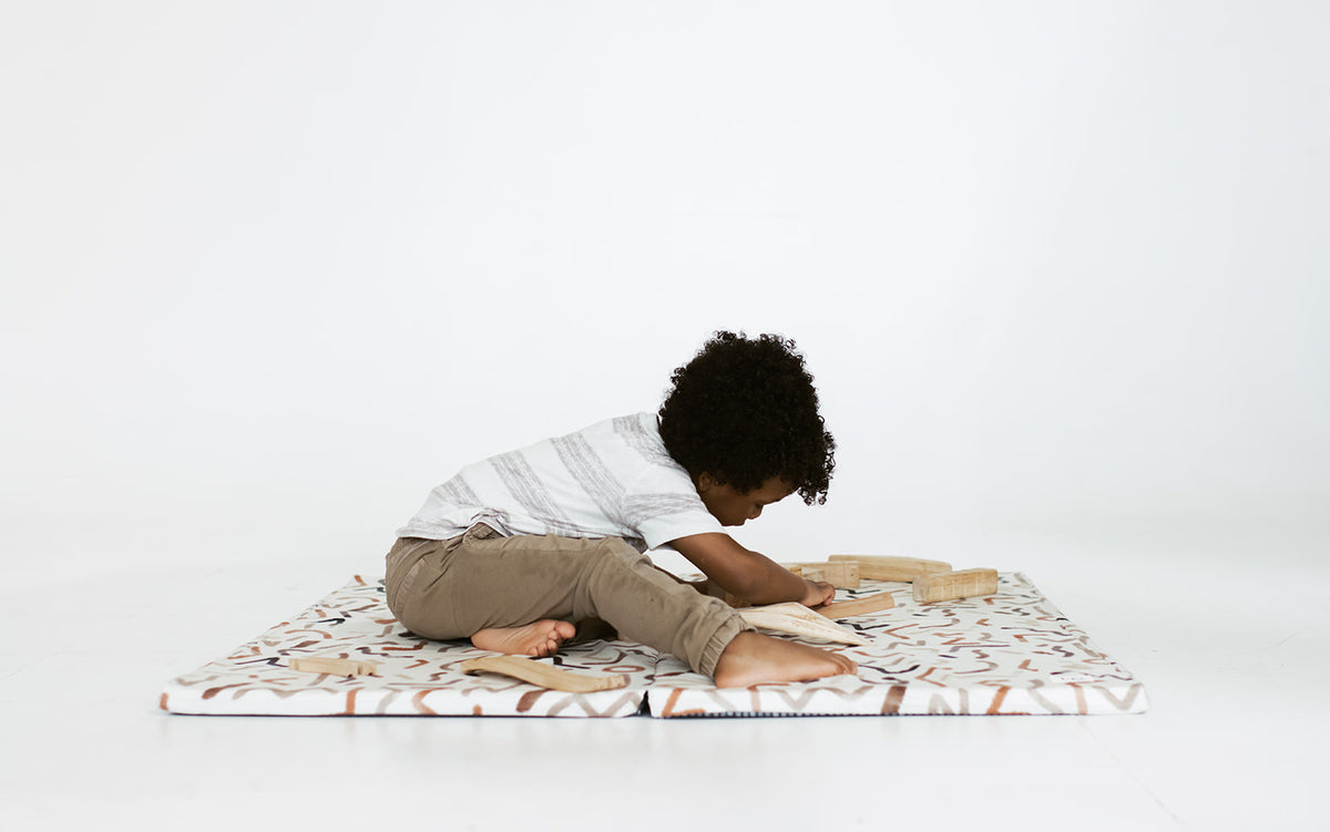 little boy playing on toki mats play mat