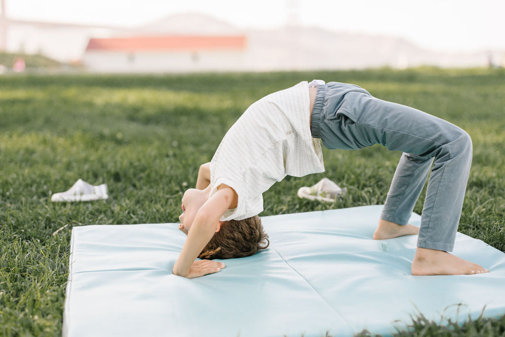 child playing outside on a toki mats play mat
