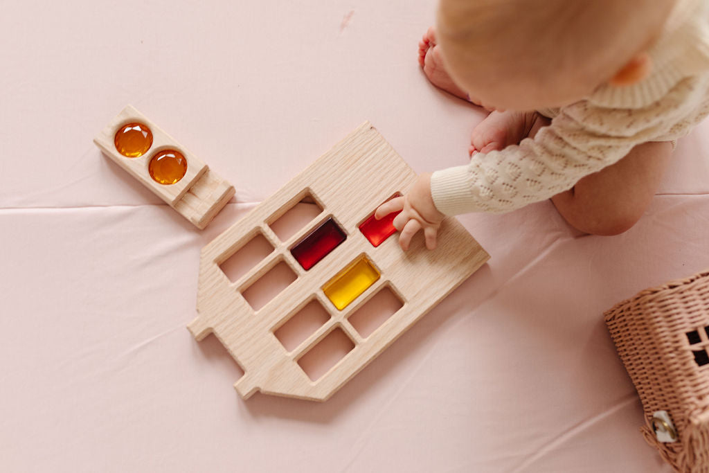 baby playing with toys on a toki mats play mat