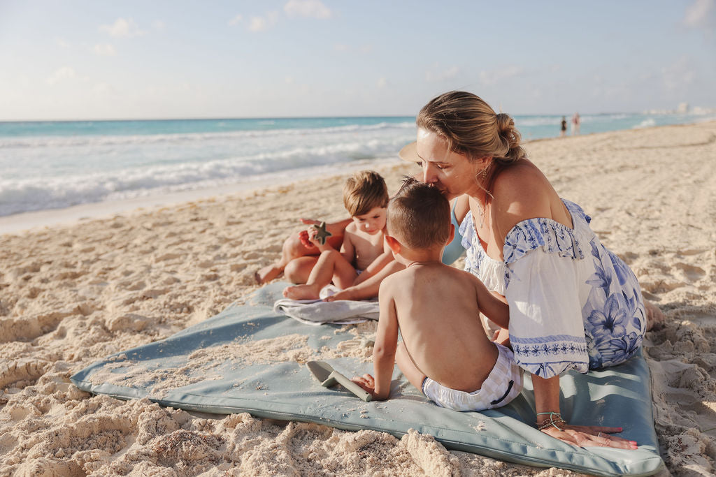 mom on the beach with her kids