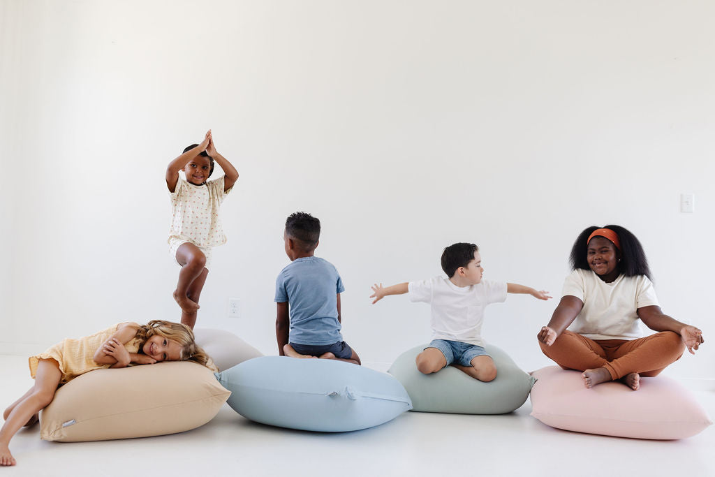 children sitting on toki mats bean bags