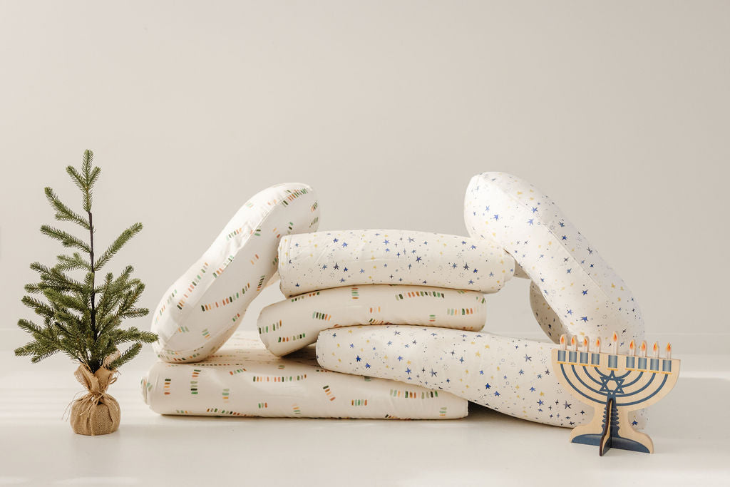 folded toki mats with a small fir tree and a toy menorah