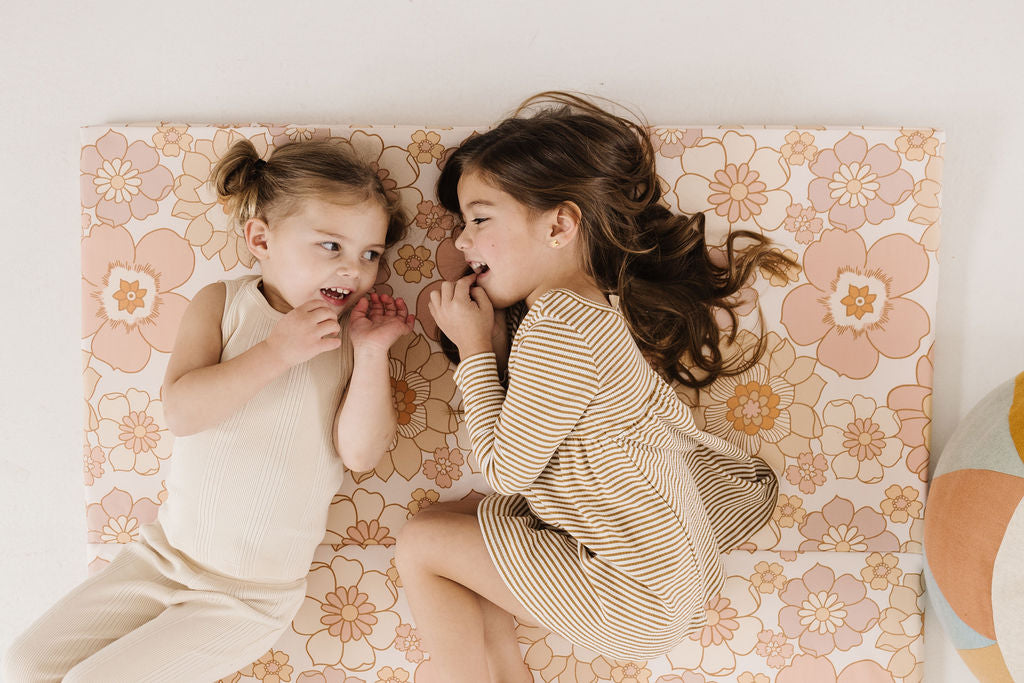 two kids laying on a vegan leather toki mat