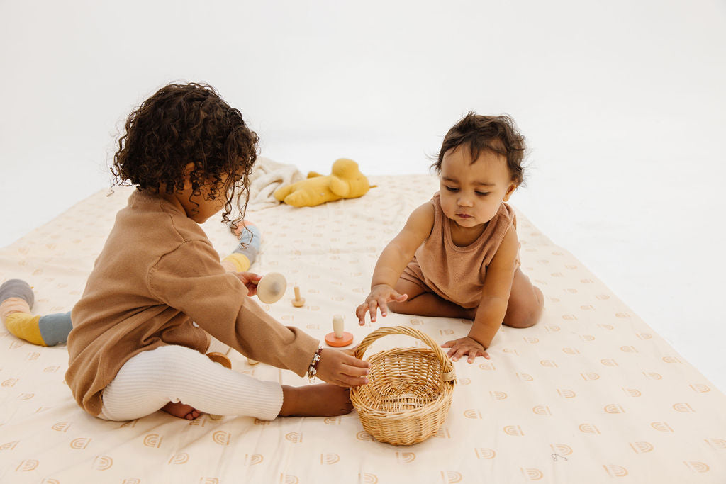 two babies playing on a toki mats play mat
