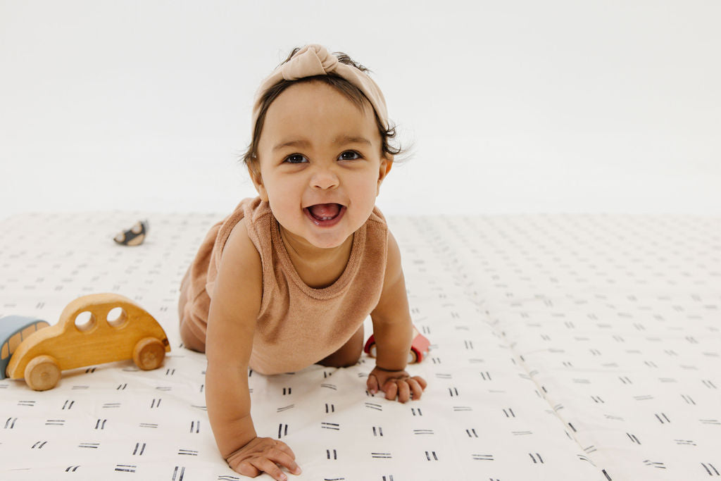 baby playing on a toki mats play mat
