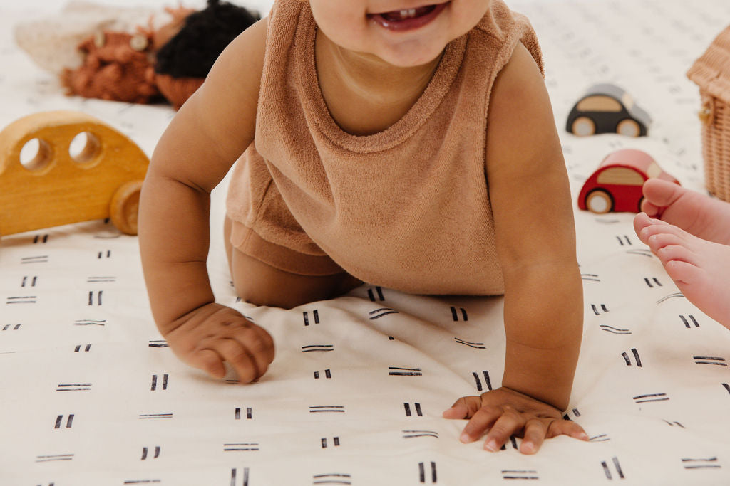baby crawling on a toki mats play mat