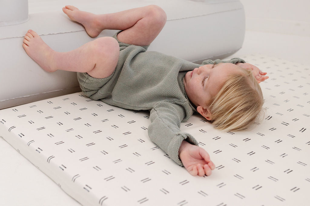 toddler playing on a toki mats play cushion