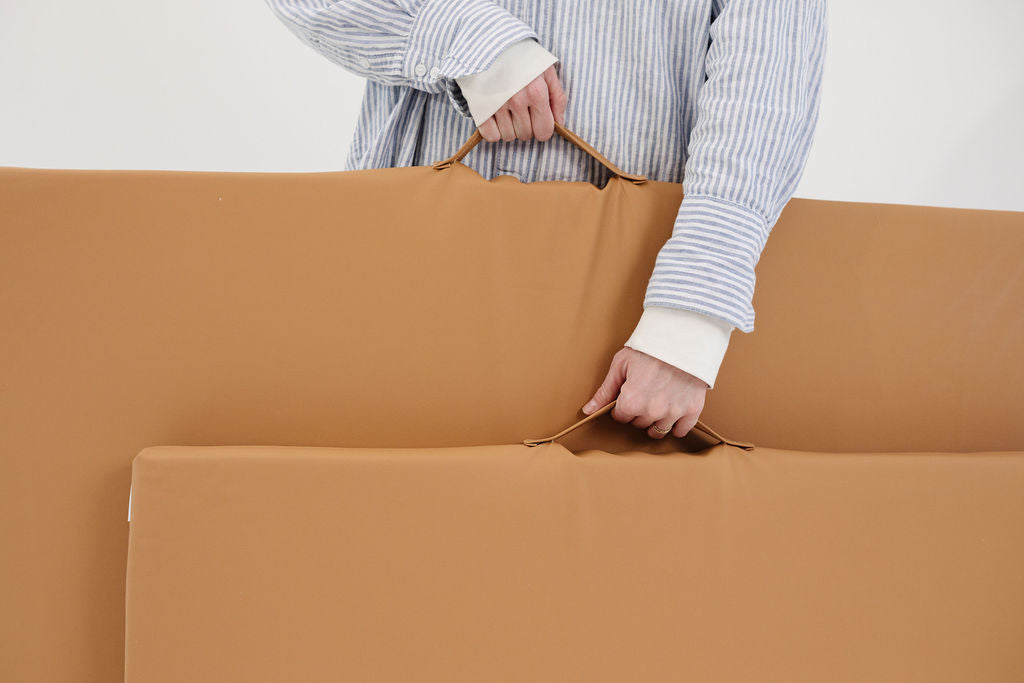 person holding toki mats play cushions