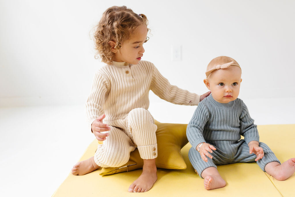 baby and toddler playing on a toki mats play mat