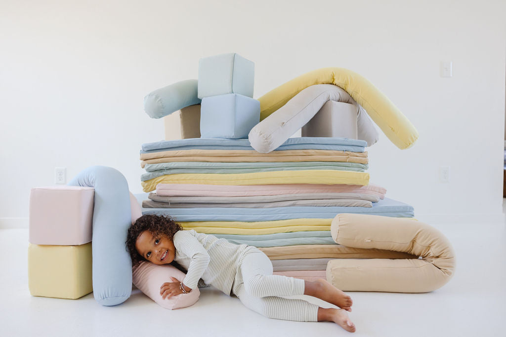 child laying on toki products